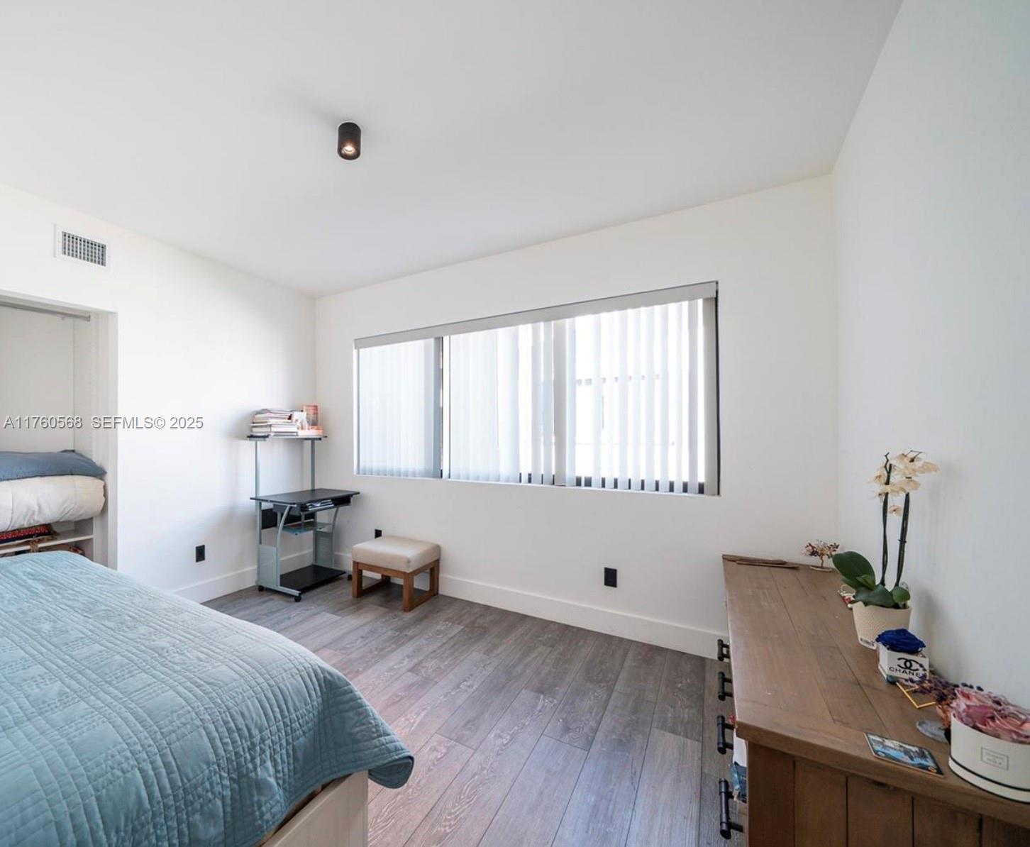 19600 Northeast 19th Avenue Miami, FL 33179 - Photo 23 of 33 a bed room with a bed and a chair