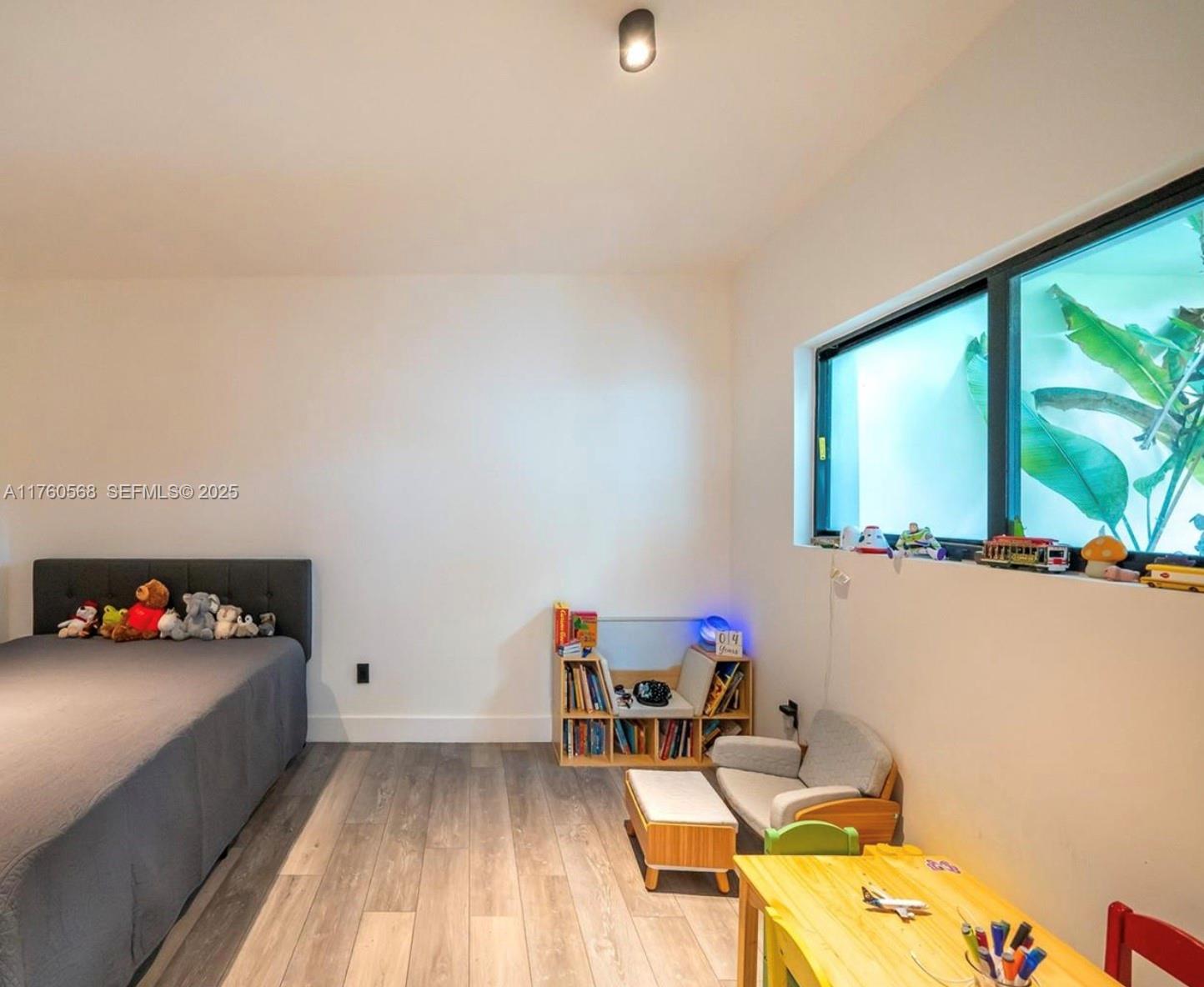 19600 Northeast 19th Avenue Miami, FL 33179 - Photo 26 of 33 a living room with furniture and a flat screen tv