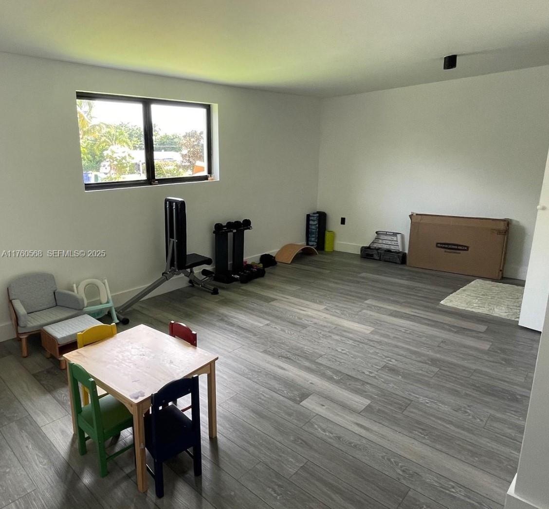 19600 Northeast 19th Avenue Miami, FL 33179 - Photo 28 of 33 a workspace with furniture hardwood and a window