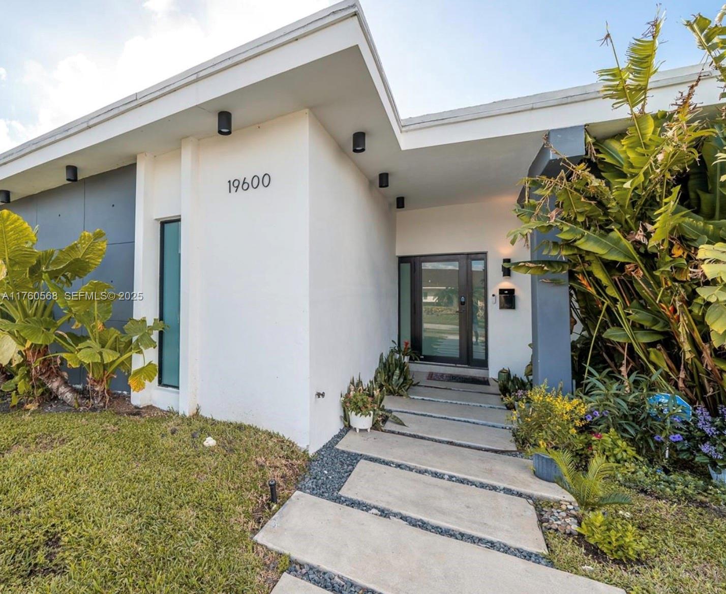 19600 Northeast 19th Avenue Miami, FL 33179 - Photo 3 of 33 a front view of a house with a yard