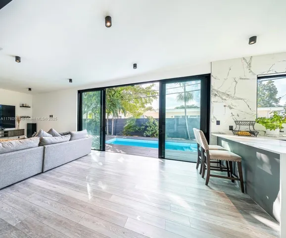 a large white kitchen with a large window