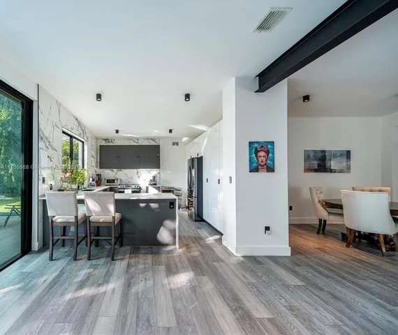 a view of a dining room with furniture window and wooden floor