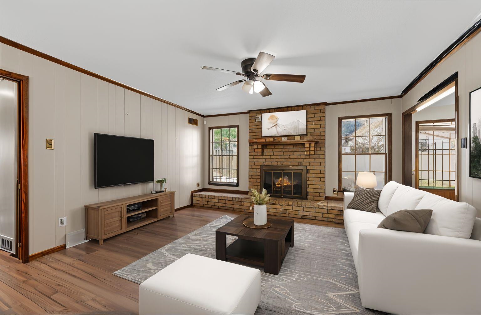 3095 Spring Hill Cove Memphis, TN 38127 - Photo 12 of 29 a living room with furniture a flat screen tv and a fireplace