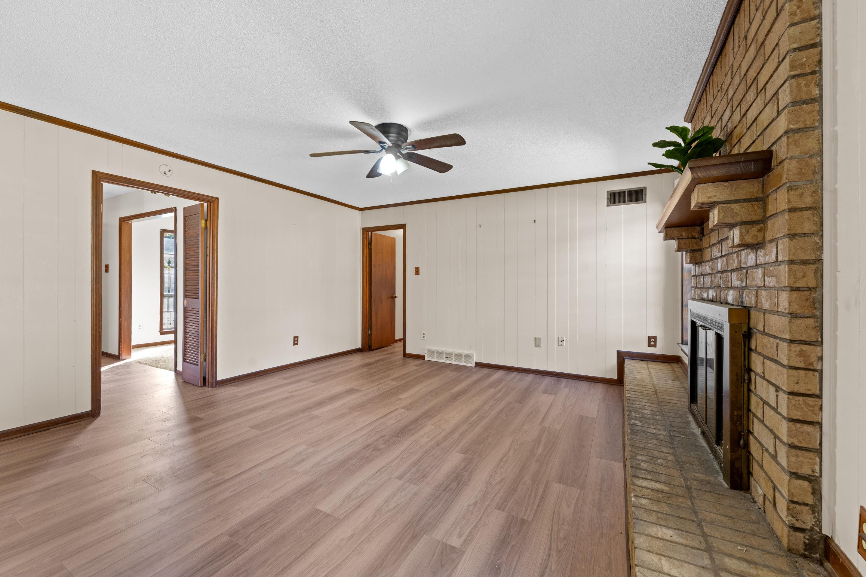 3095 Spring Hill Cove Memphis, TN 38127 - Photo 14 of 29 wooden floor in an empty room with a window