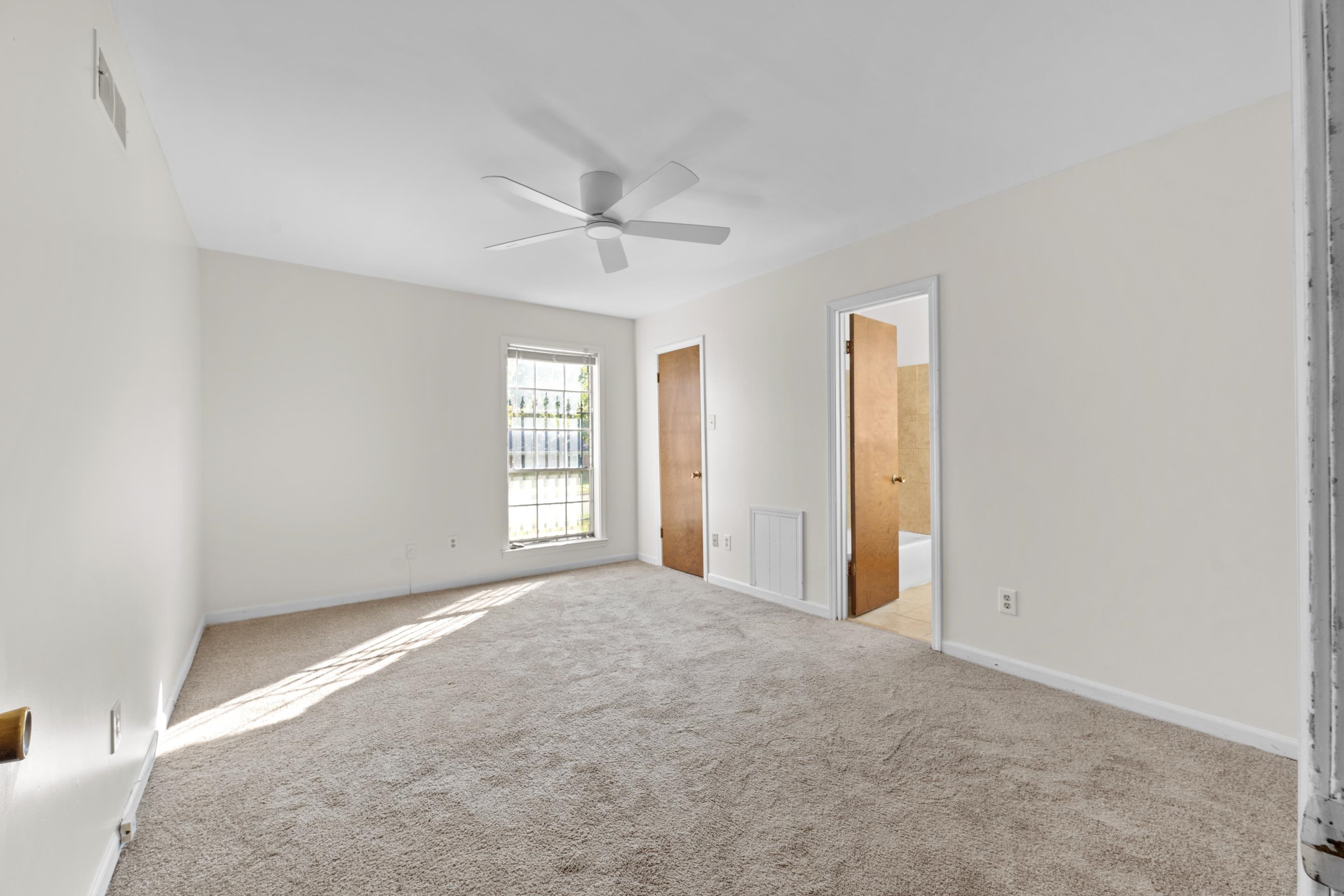 3095 Spring Hill Cove Memphis, TN 38127 - Photo 21 of 29 an empty room with windows and fan