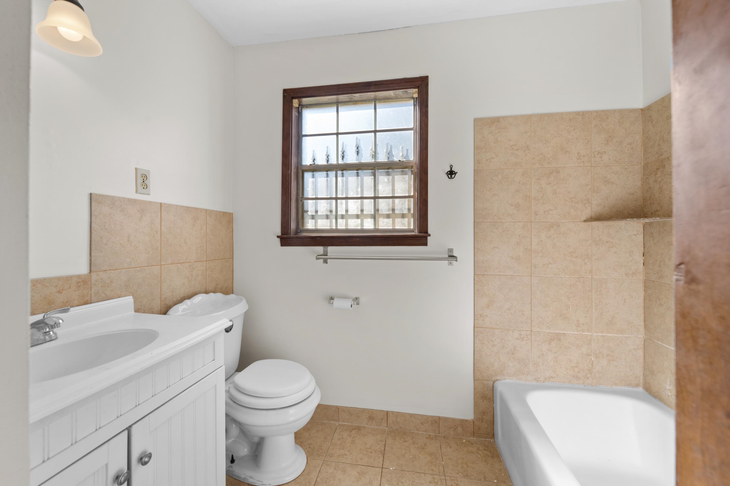 3095 Spring Hill Cove Memphis, TN 38127 - Photo 23 of 29 a white toilet sitting next to a bathroom sink