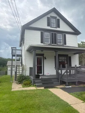 a front view of a house with a yard