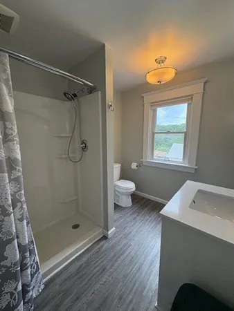 a bathroom with a toilet sink and shower