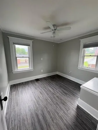 wooden floor in an empty room with a window