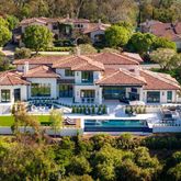 a front view of a house with swimming pool patio and fire pit