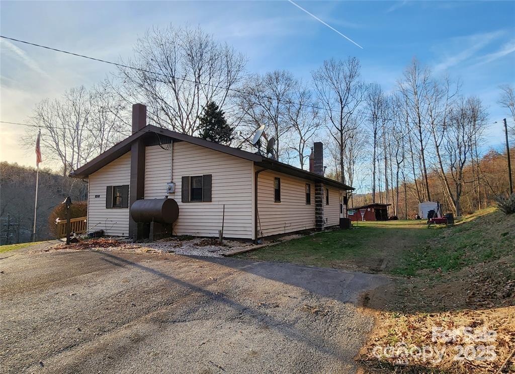 433 Deneen Road Burnsville, NC 28714 - Photo 24 of 32 a backyard of a house with wooden fence and large trees