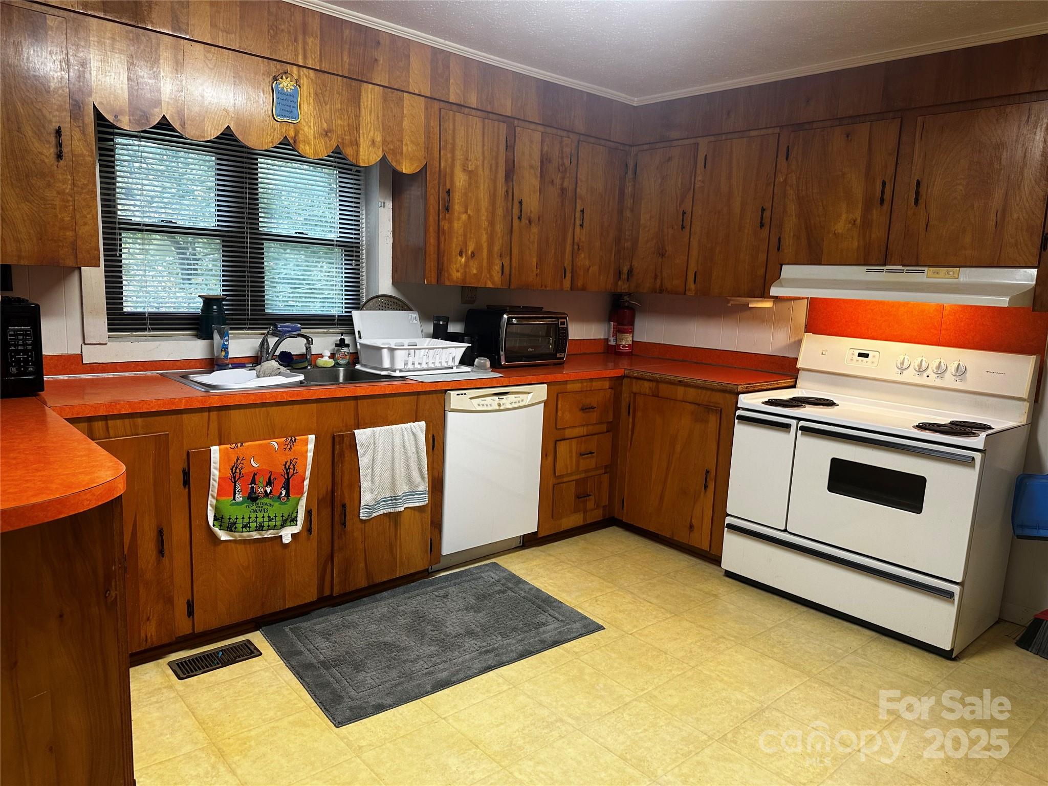 433 Deneen Road Burnsville, NC 28714 - Photo 6 of 32 a kitchen with a stove a sink and a cabinets