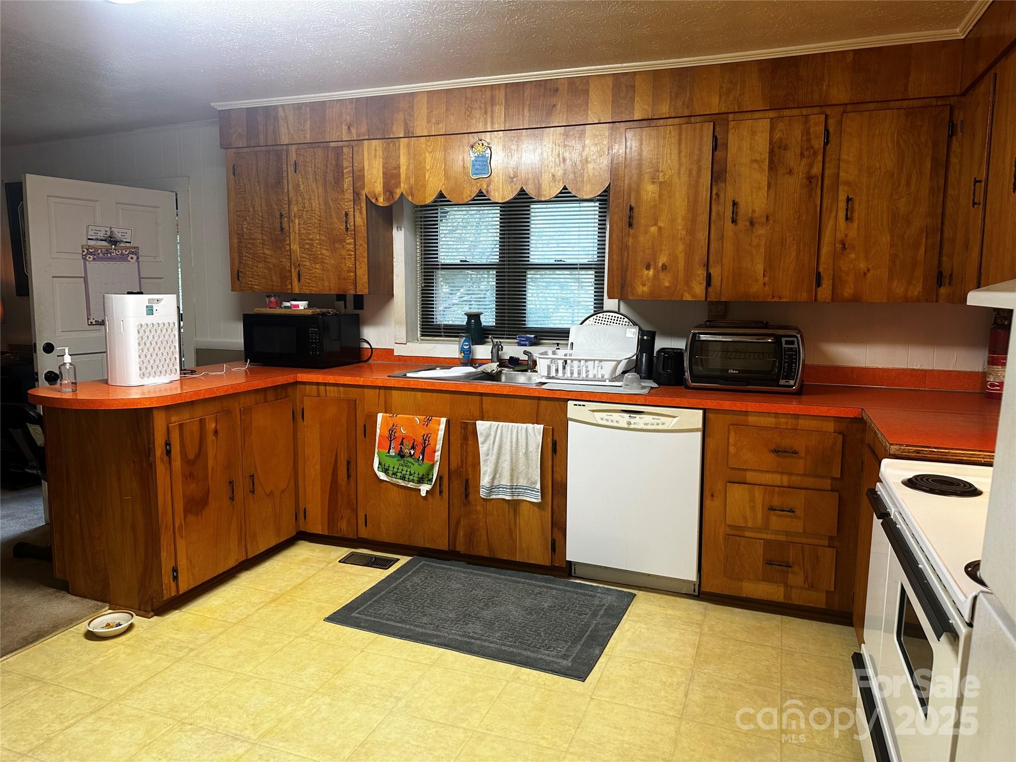 433 Deneen Road Burnsville, NC 28714 - Photo 7 of 32 a kitchen with a sink stove and cabinets