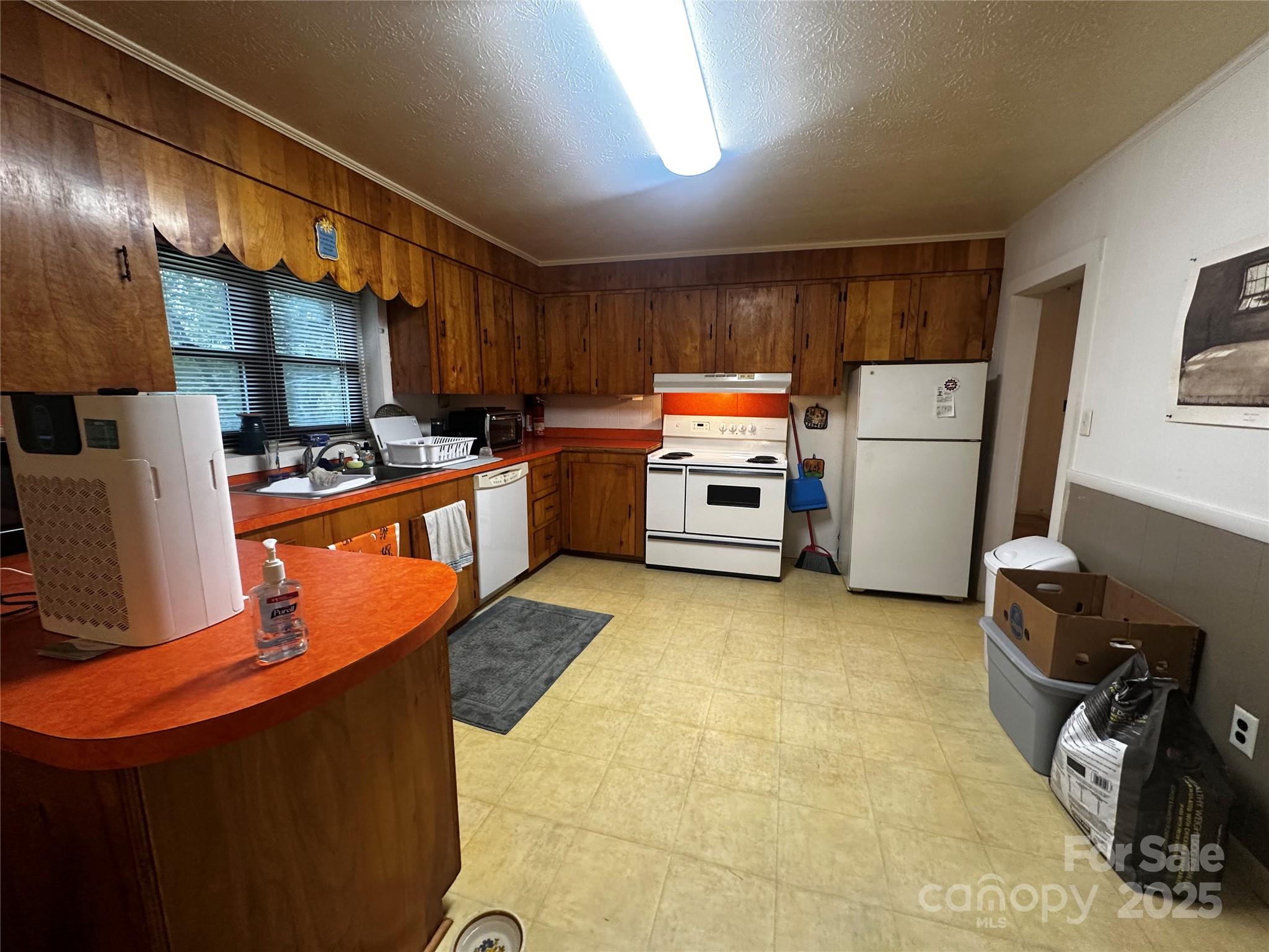 433 Deneen Road Burnsville, NC 28714 - Photo 8 of 32 a kitchen with a sink a stove and a refrigerator