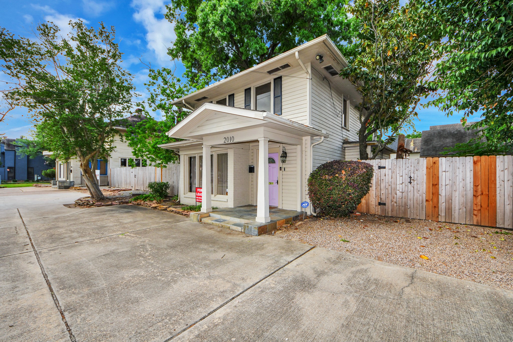 2014 Commonwealth Street Houston, TX 77006 - Photo 25 of 49 a view of a white house with a small yard and large trees