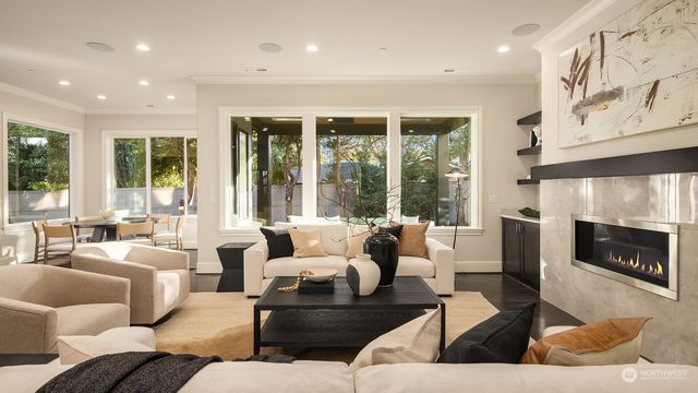 a living room with furniture large window and fireplace
