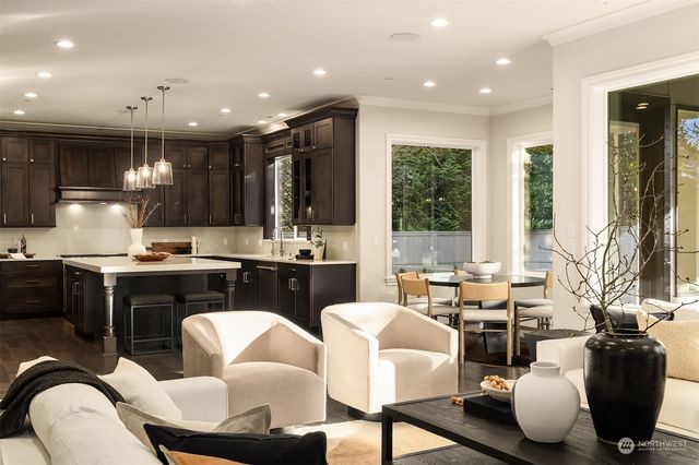 a living room with furniture kitchen and a large window