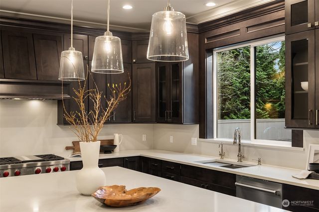 a kitchen with a sink and a large window
