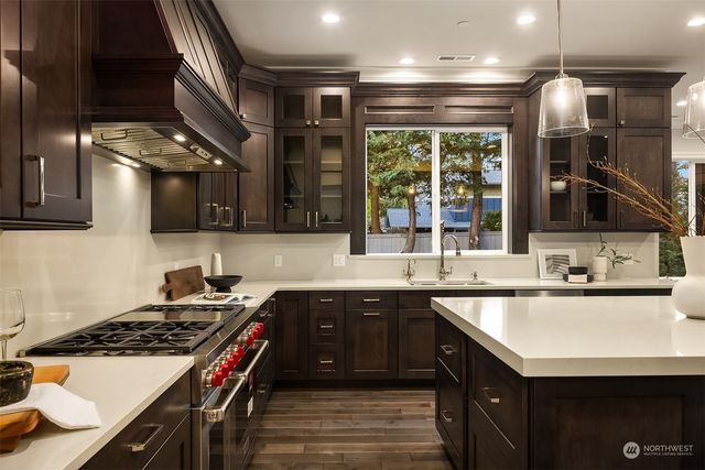a kitchen with a sink stove and cabinets
