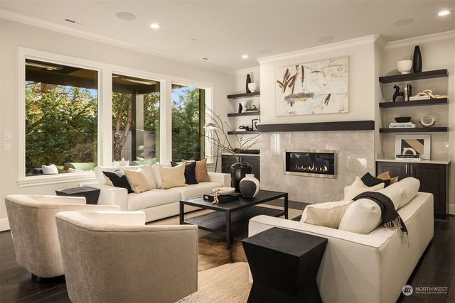 a living room with furniture large window and a fireplace