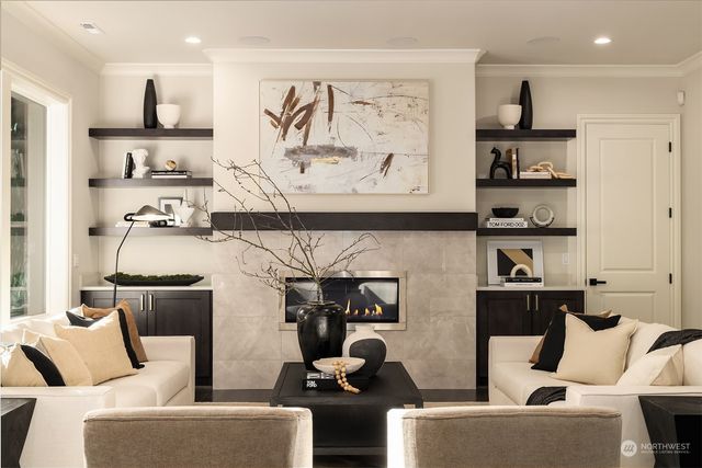 a living room with furniture and wall paintings