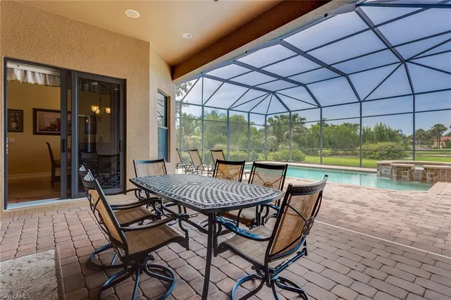 a view of a patio with a table and chairs under an umbrella