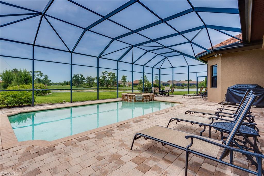 7771 Cottesmore Drive Naples, FL 34113 - Photo 13 of 32 a view of a swimming pool with a patio