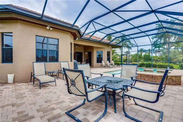 a building outdoor space with patio furniture and potted plants