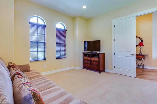 a bedroom with a bed and a television