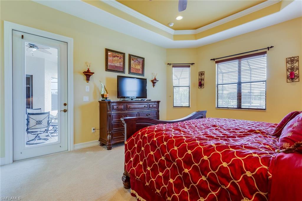 7771 Cottesmore Drive Naples, FL 34113 - Photo 21 of 32 a bedroom with a bed and a flat screen tv