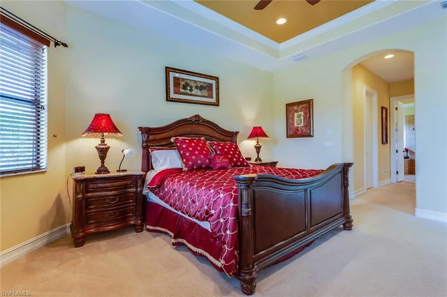 a living room with a bed and paintings on the wall