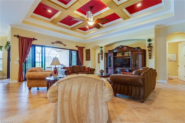 a living room with furniture a rug and a large window