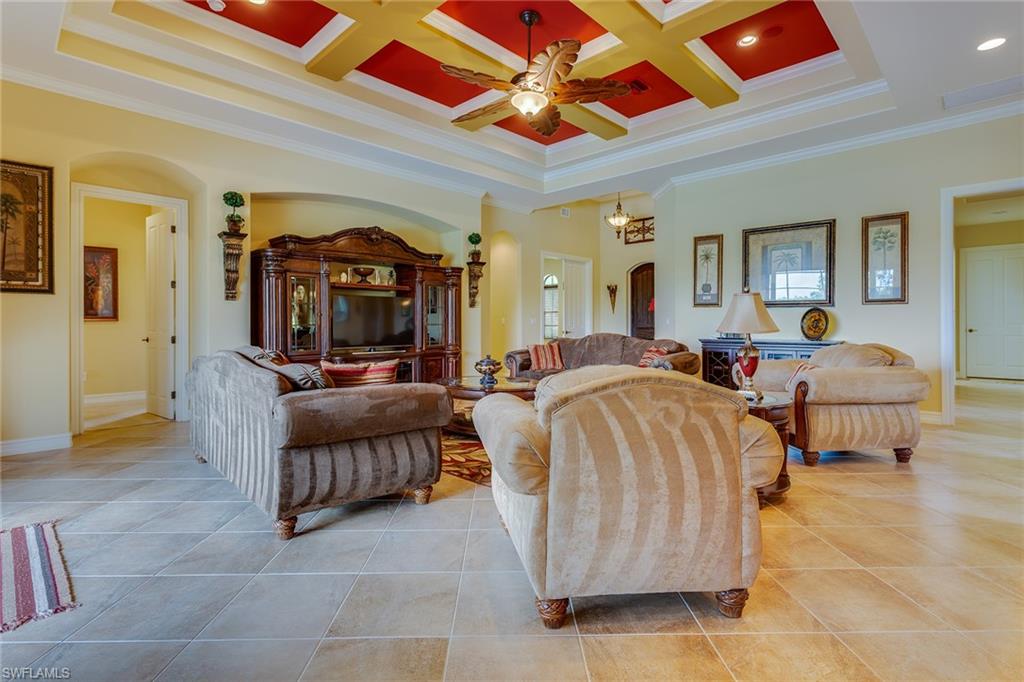 7771 Cottesmore Drive Naples, FL 34113 - Photo 4 of 32 a living room with furniture and a flat screen tv
