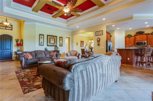 a living room with furniture a wooden floor and chandelier