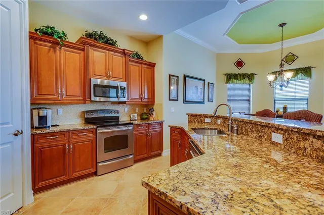a kitchen with stainless steel appliances granite countertop a sink and a stove