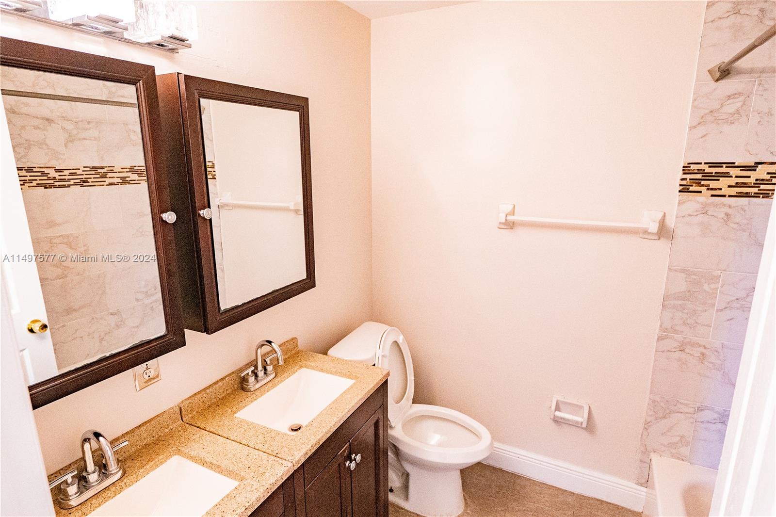 Shenandoah Davie, FL 33325 - Photo 37 of 61 a bathroom with a sink mirror vanity and toilet