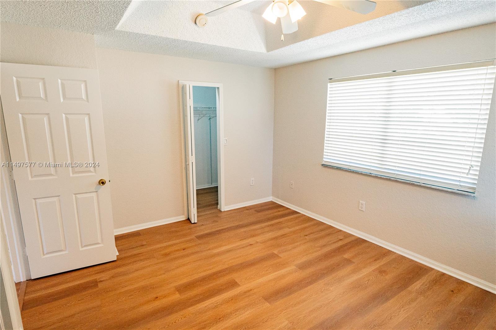 Shenandoah Davie, FL 33325 - Photo 42 of 61 a view of an empty room with wooden floor and a window