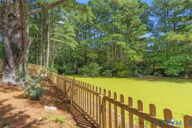 a view of a garden with wooden fence