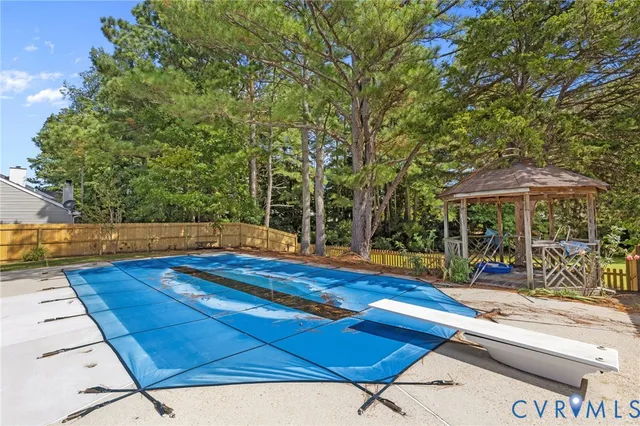 a view of swimming pool with chairs in patio