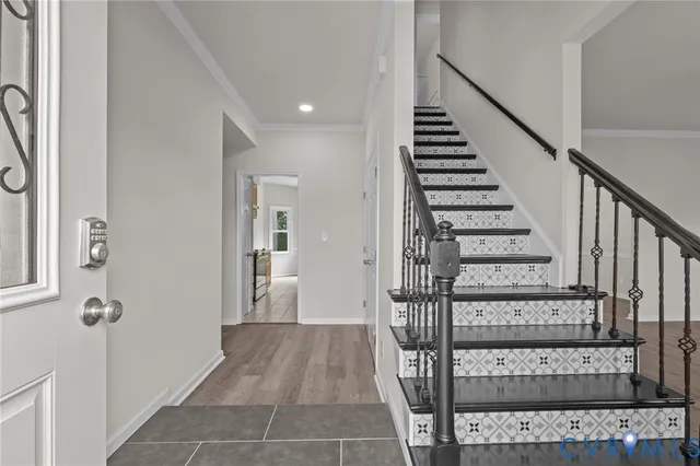 a view of a hallway with wooden floor and entryway