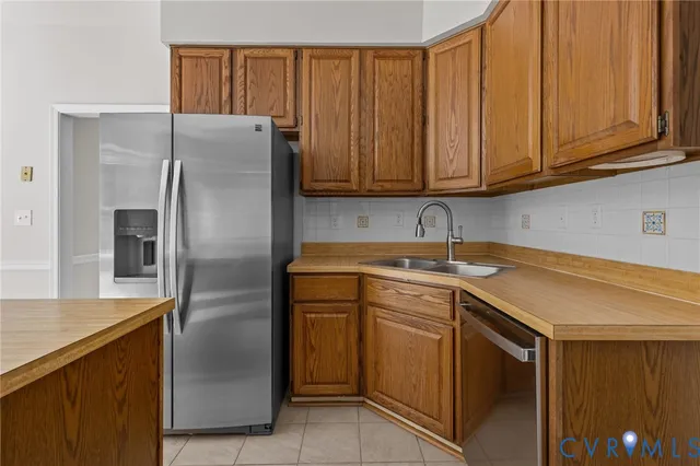 a kitchen with stainless steel appliances granite countertop a refrigerator sink and cabinets