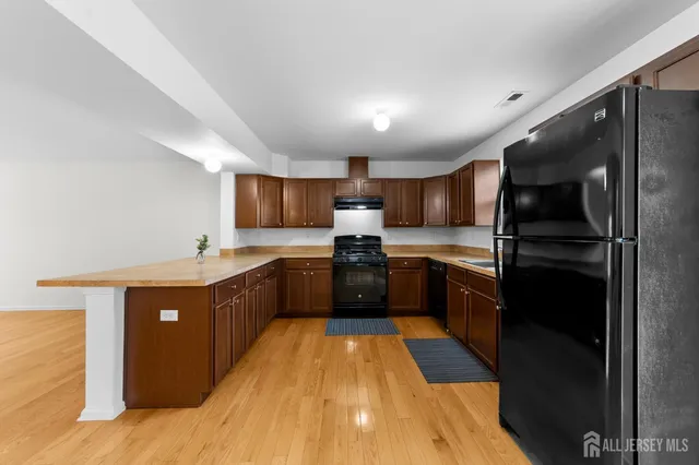 a kitchen with a sink stove top oven and cabinets
