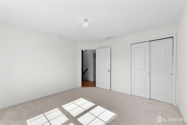 a bathroom with a granite countertop toilet a sink and a mirror
