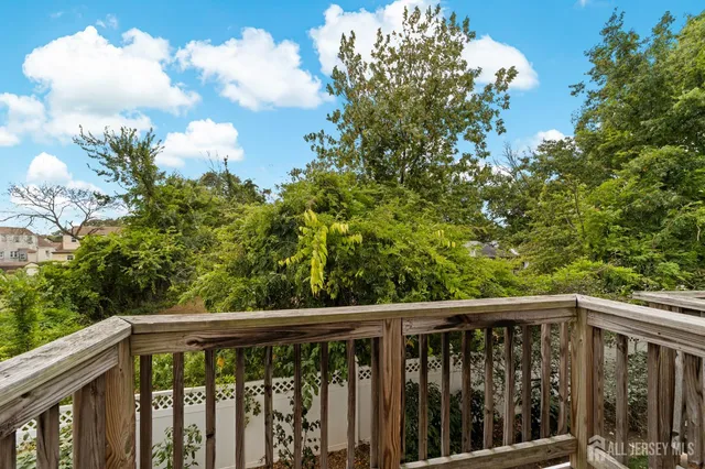 a view of a wooden bench sitting in front of a house