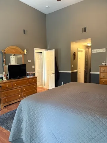 a bedroom with a bed and a flat screen tv