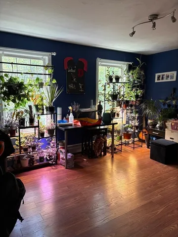 a living room filled with furniture and a large window