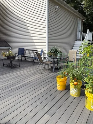 a view of a deck with chairs and potted plants