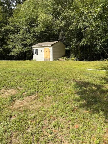a backyard of a house with large trees