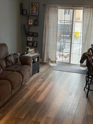 a living room with furniture and a floor to ceiling window