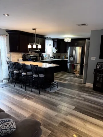 a kitchen with a sink appliances and cabinets